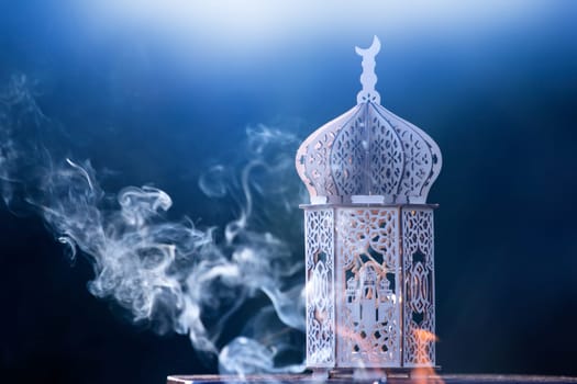 Ornamental Arabic lantern with smoke. Festive greeting card for Muslim holy month Ramadan Kareem.