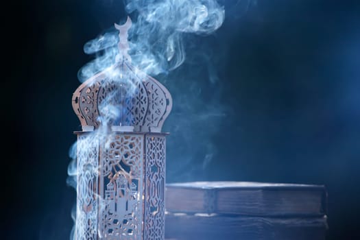 Ornamental Arabic lantern with with Holy Quran. Festive greeting card for Muslim holy month Ramadan Kareem.