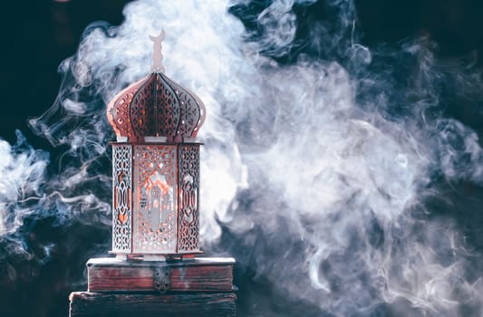Ornamental Arabic lantern with with Holy Quran. Festive greeting card for Muslim holy month Ramadan Kareem.