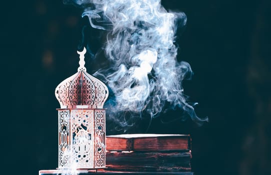 Ornamental Arabic lantern with with Holy Quran. Festive greeting card for Muslim holy month Ramadan Kareem.