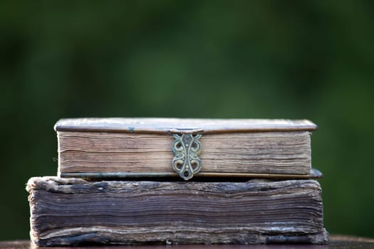 Literature, reading concept: banner or header image with stack of antique books against a dark background