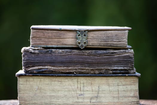 Literature, reading concept: banner or header image with stack of antique books against a dark background