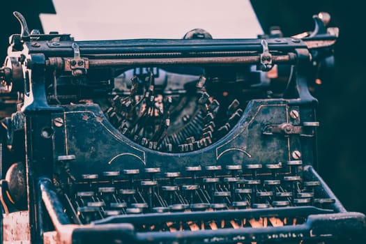 Antique typewriter. Vintage typewriter machine closeup photo.