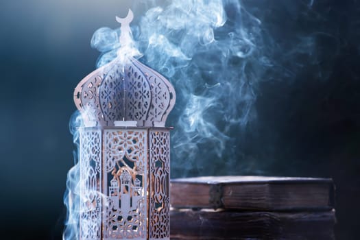 Ornamental Arabic lantern with with Holy Quran. Festive greeting card for Muslim holy month Ramadan Kareem.