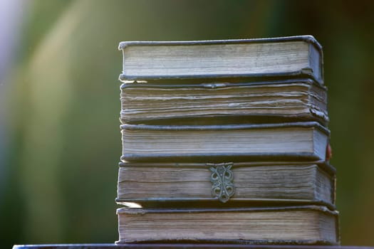Literature, reading concept: banner or header image with stack of antique books against a dark background