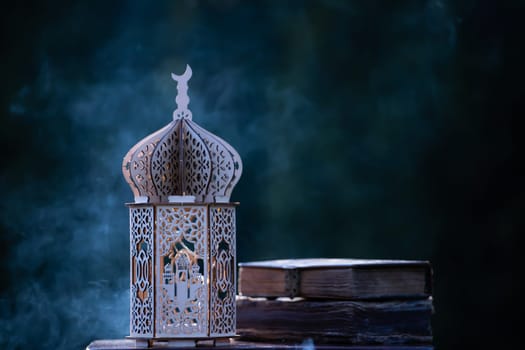Ornamental Arabic lantern with with Holy Quran. Festive greeting card for Muslim holy month Ramadan Kareem.