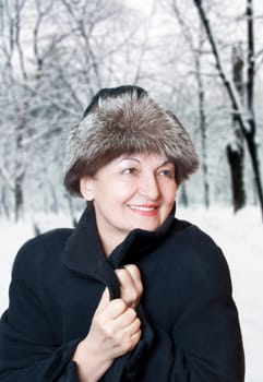 Happy elderly woman enjoy the winter
