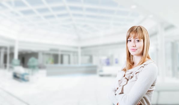 Portrait of a young attractive business woman in corporate building