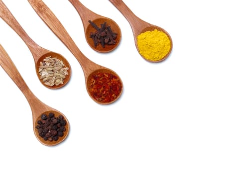 Various of spices in wooden spoon isolated over white
