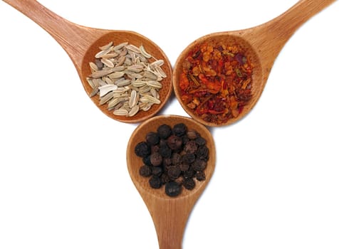 Various of spices in wooden spoon isolated over white