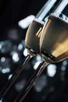 two glasses of champaign in font of the night lights