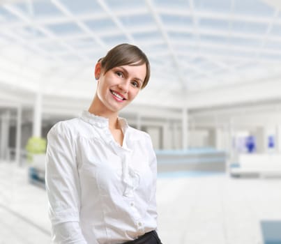 Portrait of a young attractive business woman in corporate building