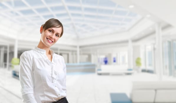 Portrait of a young attractive business woman in corporate building