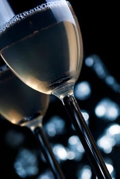 two glasses of champaigne in font of the night lights