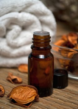Bottle of essence oil, potpourri and towel