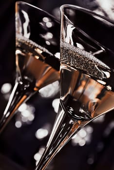 two martini  glasses in front of the night lights