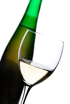 Bottle and glass of white wine over white background