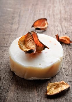 Bar of natural soap on wooden board