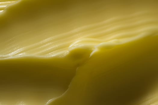 Super macro wavy margarine pattern. A common kitchen ingredient that is often touted as a healthier alternative to butter. Spreadable and yellow color