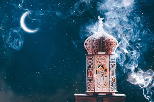 Ornamental Arabic lantern with crescent moon glowing at night. Festive greeting card for Muslim holy month Ramadan Kareem.