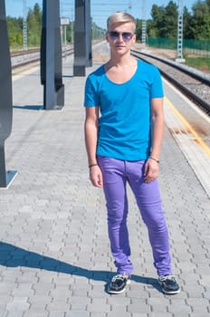 Good looking caucasian male outdoors in railway platform.