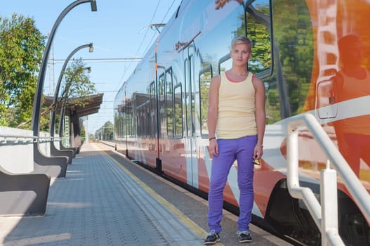 Young man on the background of the train
