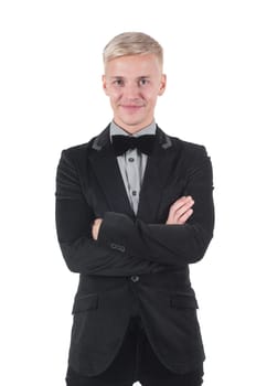 Man in jacket and bow-tie standing with crossed arms.