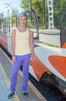 Young man on the background of the train