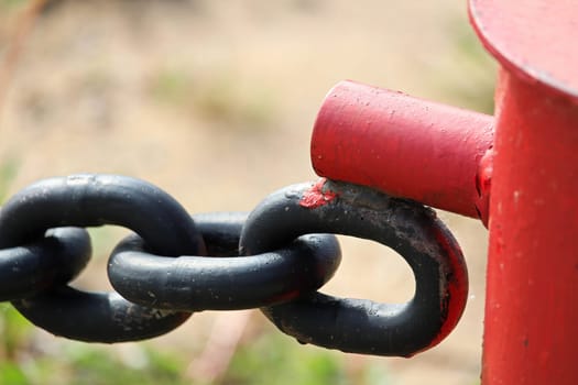 The welded clasp end where a chain link fence connects.