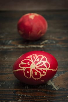 Red easter eggs on wooden plank