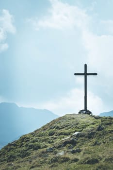 Peak with wooden summit cross in the Austrian mountains