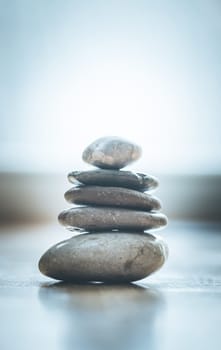Feng Shui: Stone cairn on the wooden floor, text space and cool light