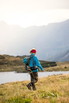 Woman in professional sportswear is hiking on the mountain, Austria