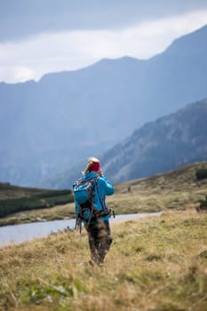 Woman in professional sportswear is hiking on the mountain, Austria