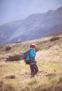 Woman in professional sportswear is hiking on the mountain, Austria