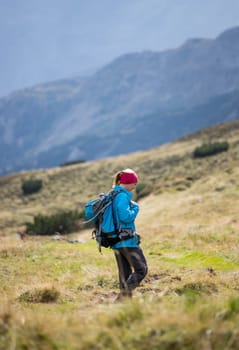 Woman in professional sportswear is hiking on the mountain, Austria