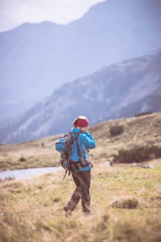 Woman in professional sportswear is hiking on the mountain, Austria