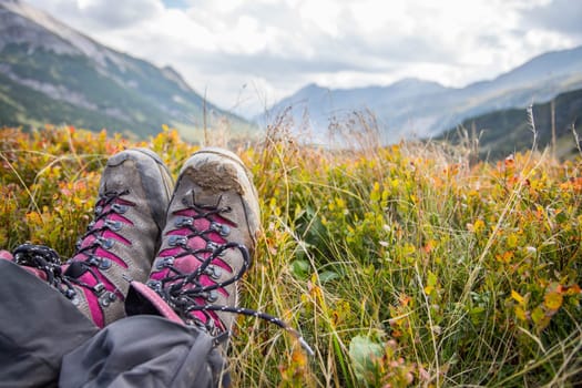 Cut out of a woman in hiking boots who is enjoying the idyllic mountain landscape