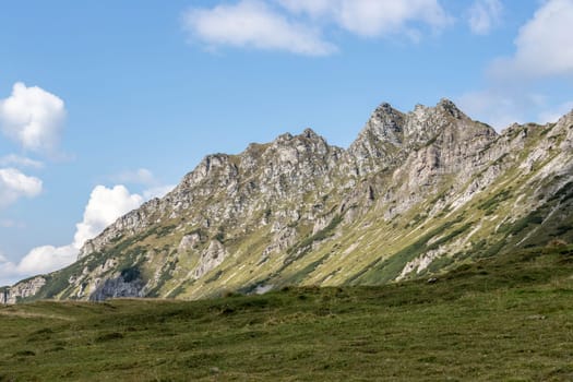 Picture of rugged mountains in the alps, blue sky with clouds