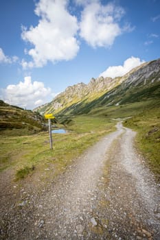 Hiking trail in the Austrian mountains, mountain range and blue sky