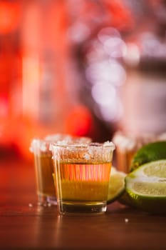 tequila , lime and salt on wooden table selective focus