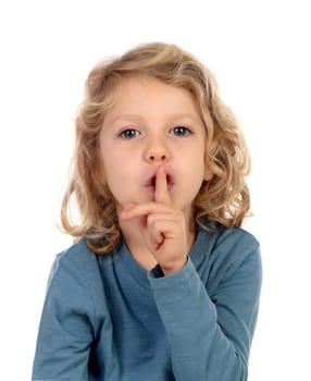 Small child putting forefinger to lips as sign of silence, isolated on a white background