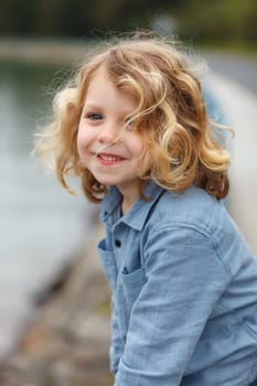 Happy small child with long blond hair enjoying the holidays
