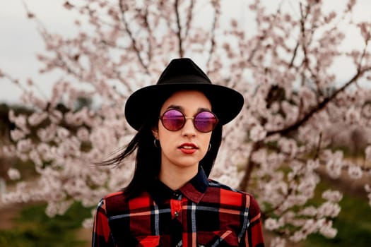 Brunette girl near a almond tree with many flowers