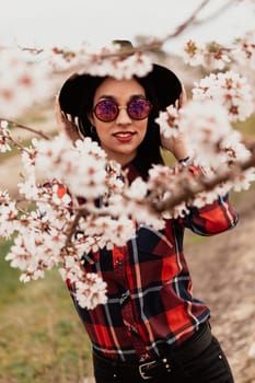 Brunette girl near a almond tree with many flowers
