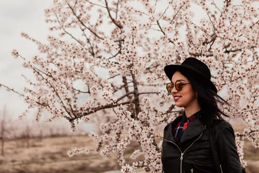 Brunette girl near a almond tree with many flowers