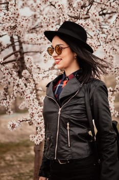 Brunette girl near a almond tree with many flowers