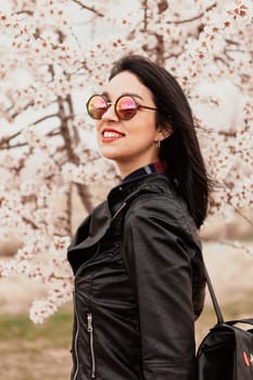 Brunette girl near a almond tree with many flowers