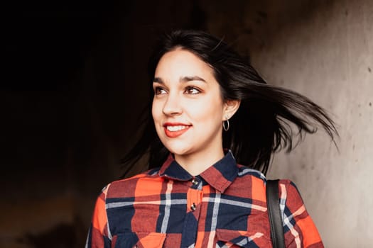 Pretty brunette girl with plaid shirt and red lips