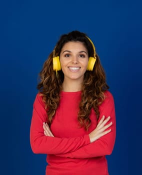 Portrait of beautiful caucasian girl with curly hair and headphones listening music isolated on a white background